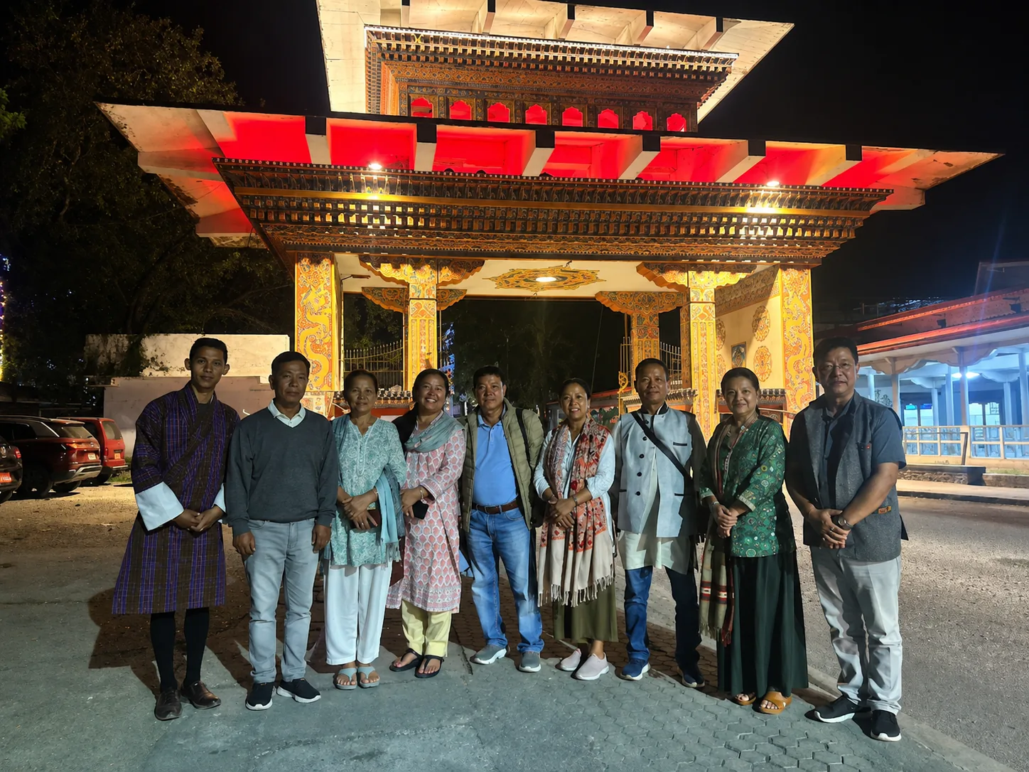Guests at the illuminated Bhutan Gate in Phuentsholing at night, at the start of a Bhutan tour package